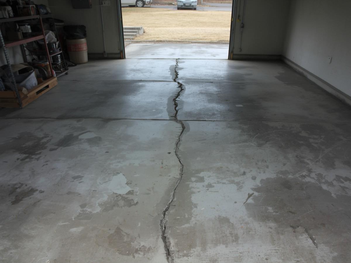 Cracked and settled residential garage floor slab